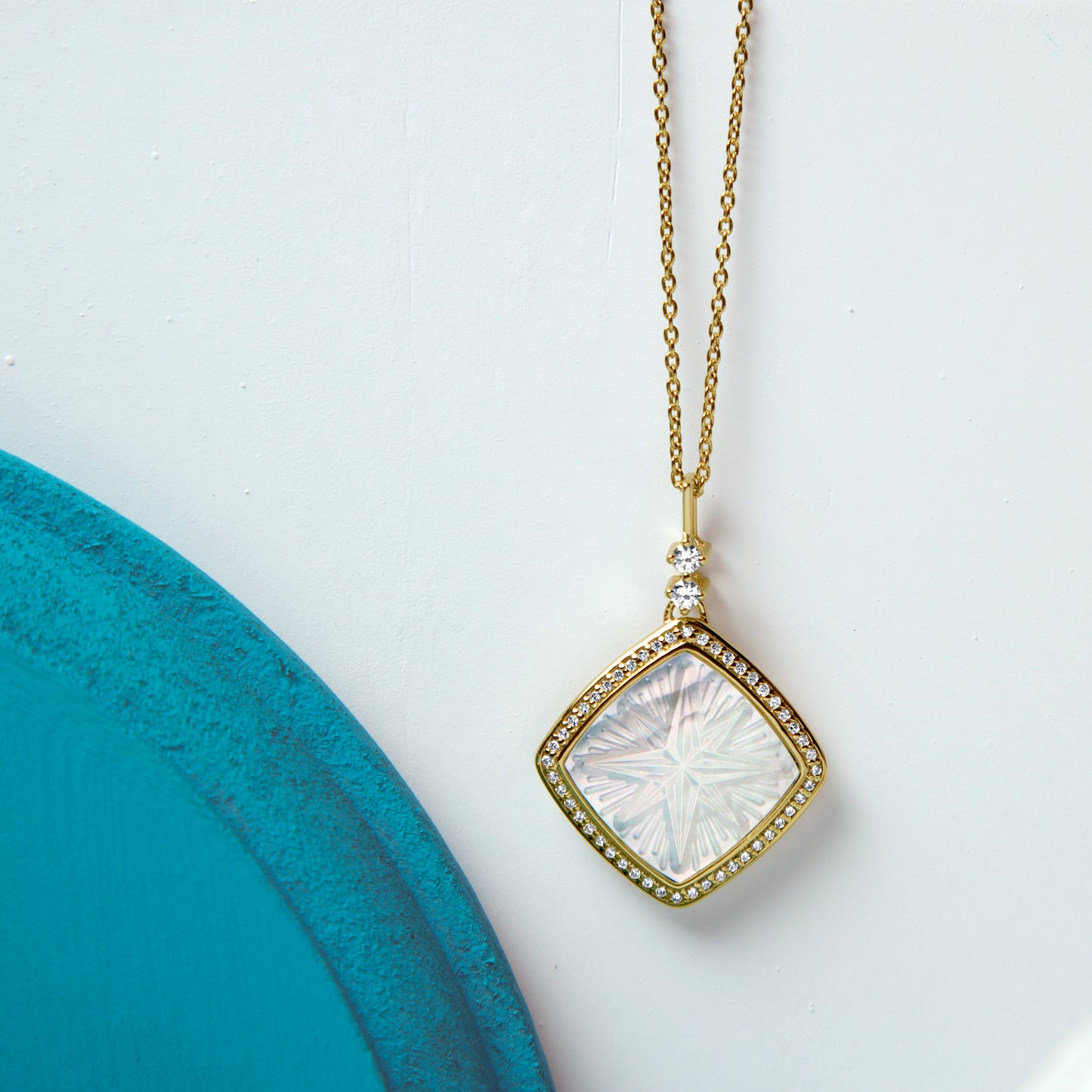 Ezme Designer Mother-of-pearl Pendant -18k Gold Plated. The magical design of the pendant captures the harmony between the se...